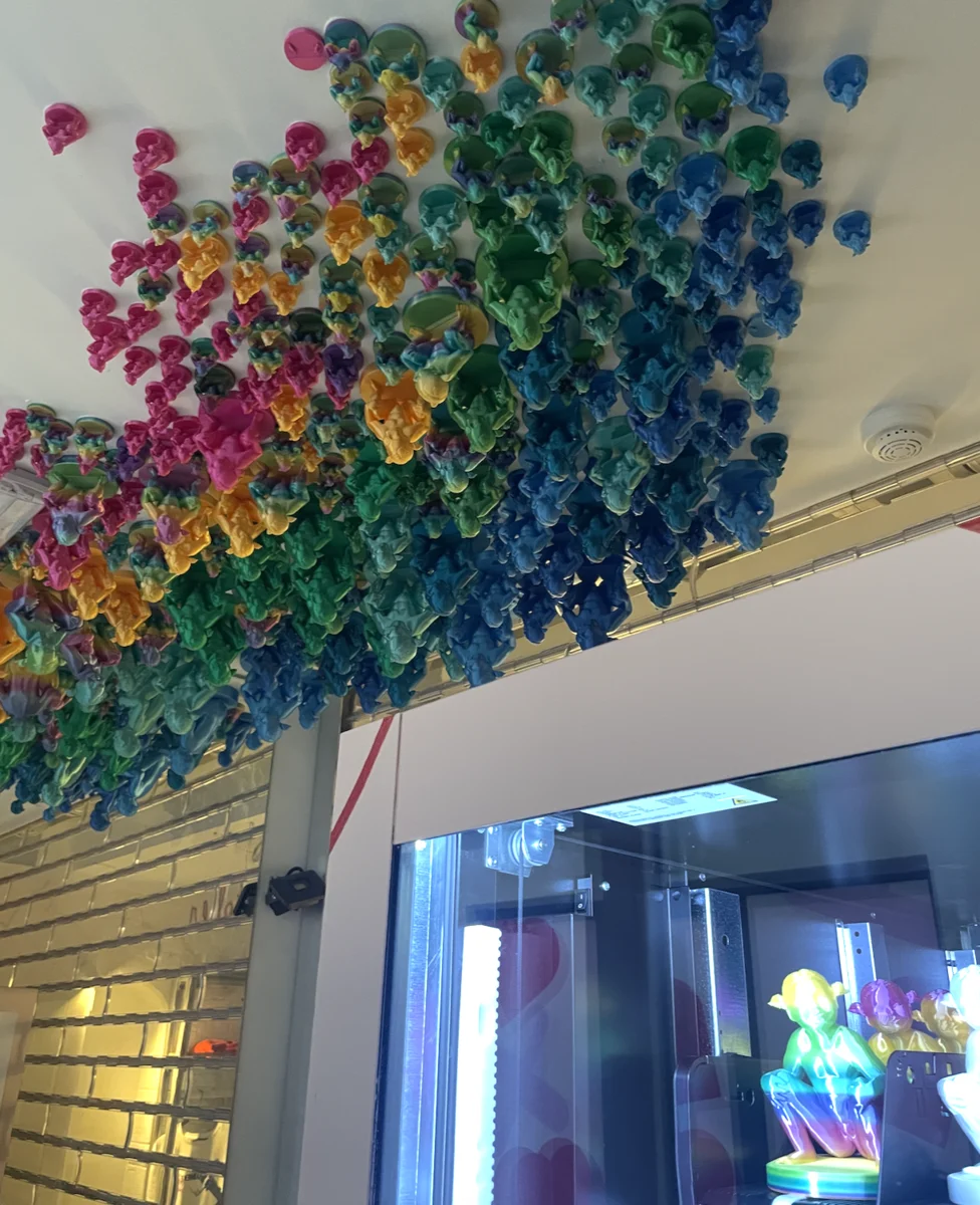 Colorful 3D printed figurines in vending machine rows