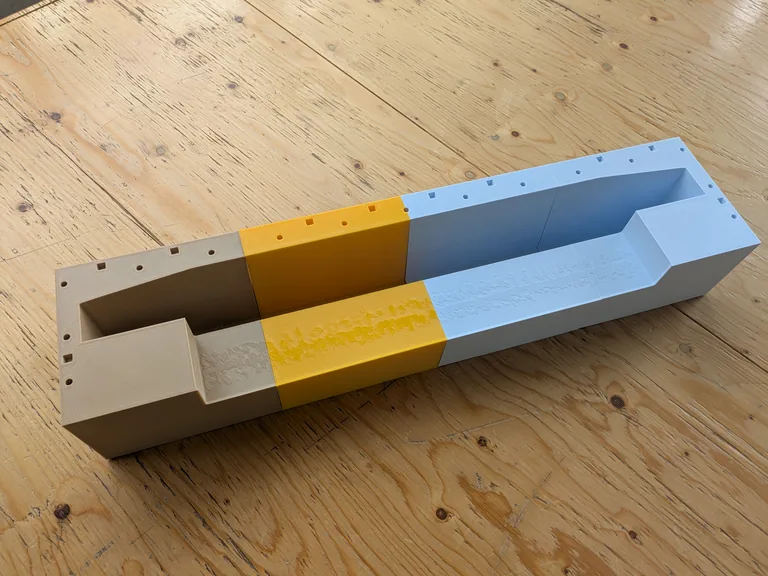 Three-part 3D printed mould for a concrete bench, assembled on a wooden table in the MadeInBXL workshop in Brussels